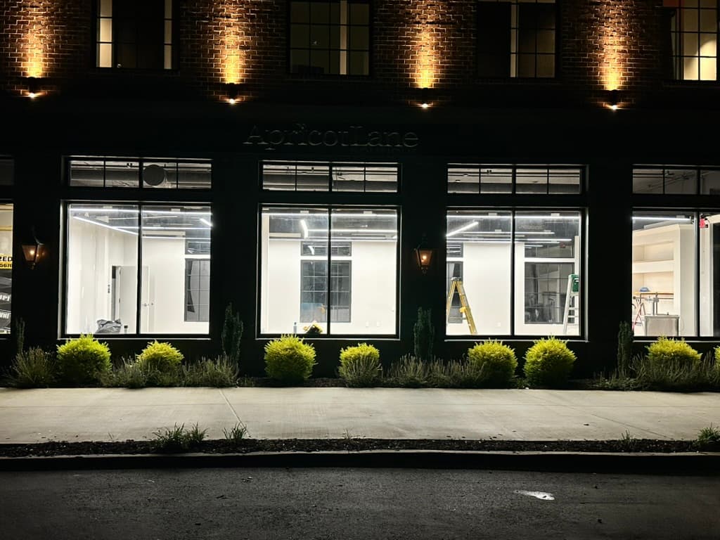 Apricot Lane boutique storefront with bright LED interior and warm exterior accent lighting