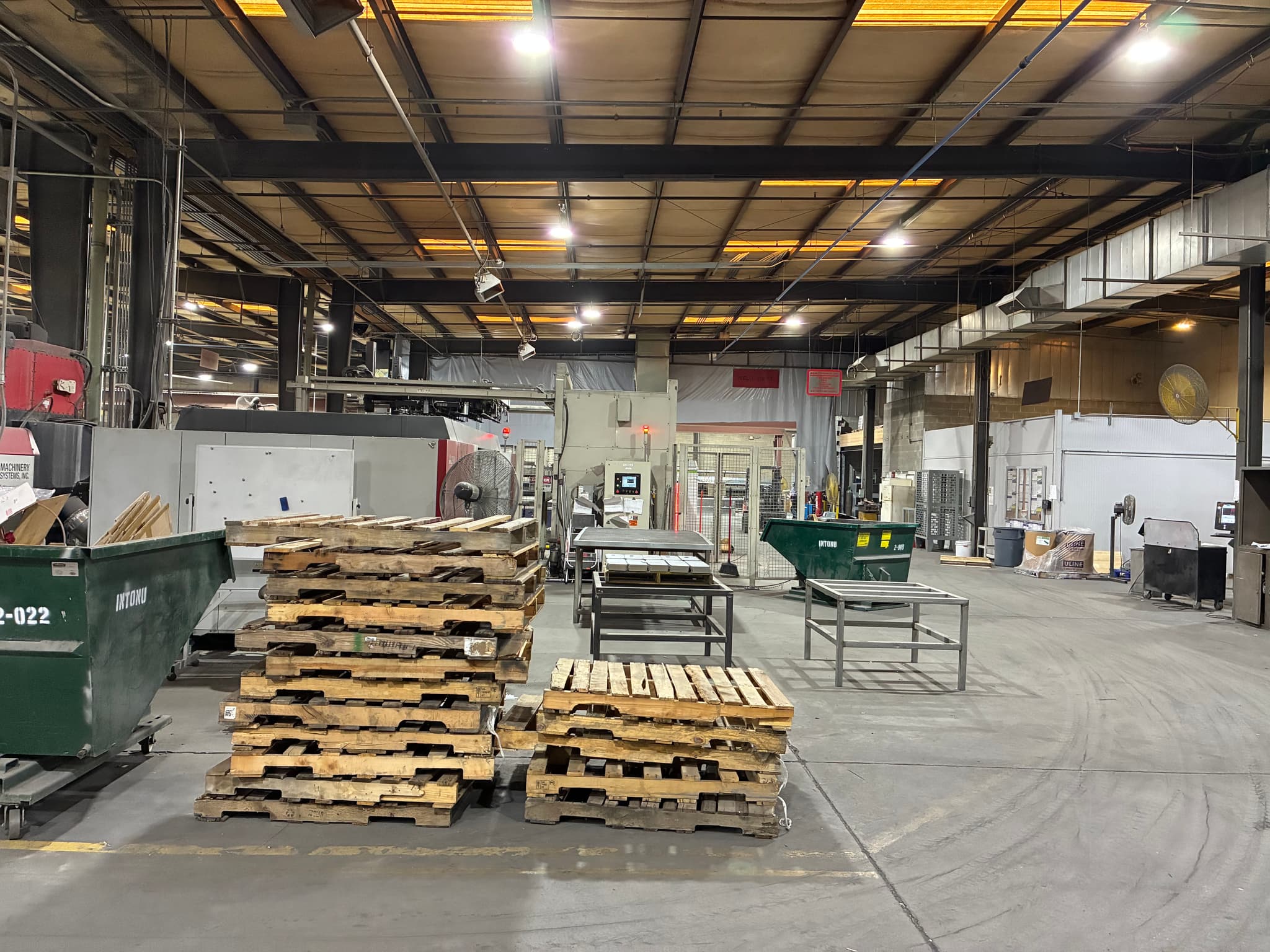 Bright LED high-bays illuminating active metal fabrication warehouse