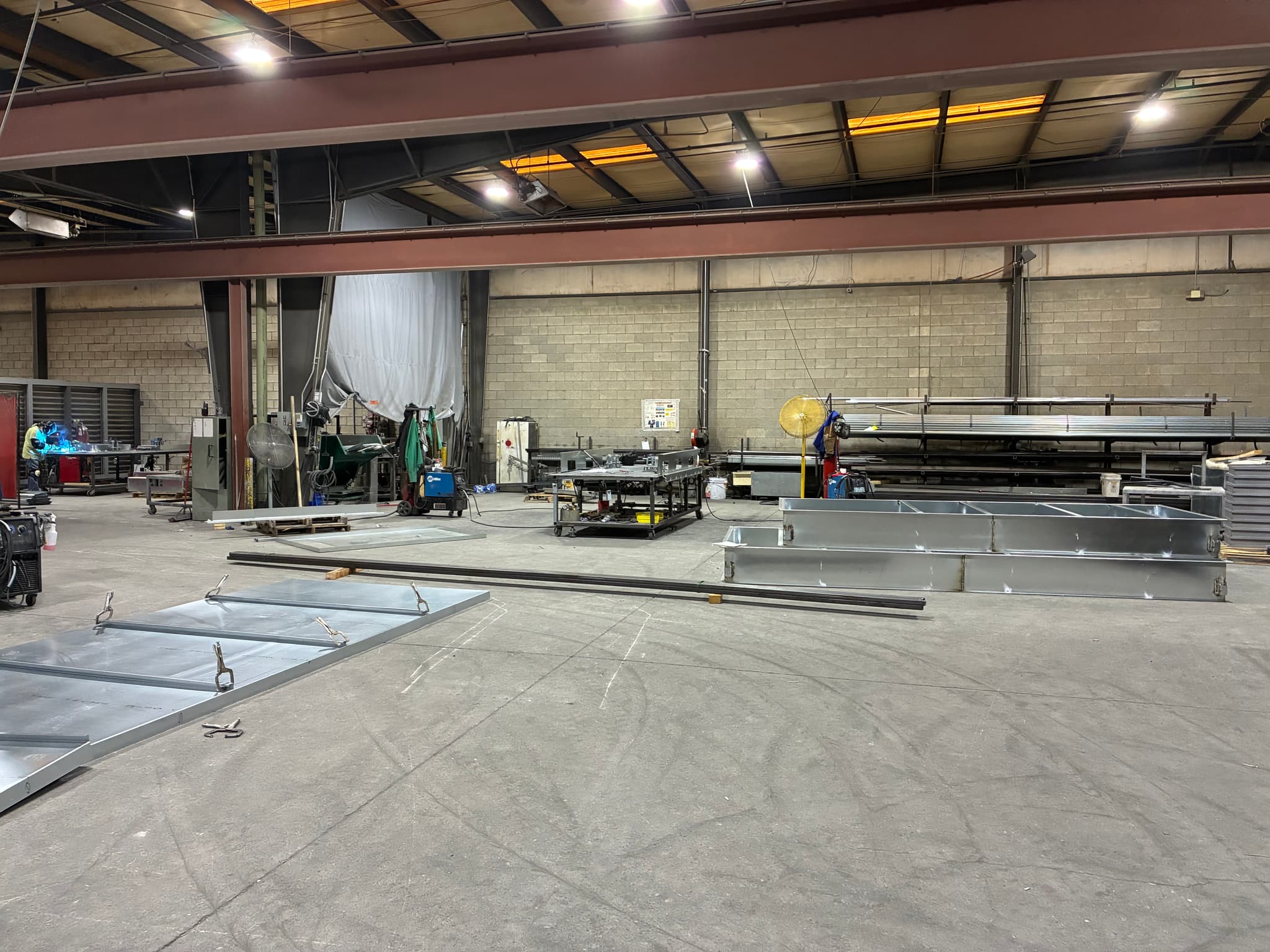 Bright LED lighting over active industrial welding and fabrication area